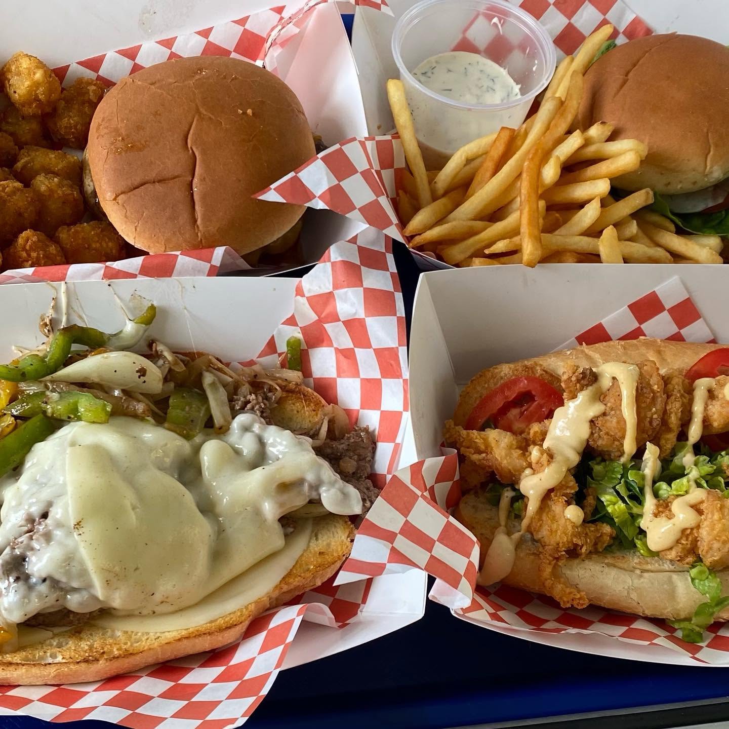 Four baskets of V9 burgers, sandwiches and fries