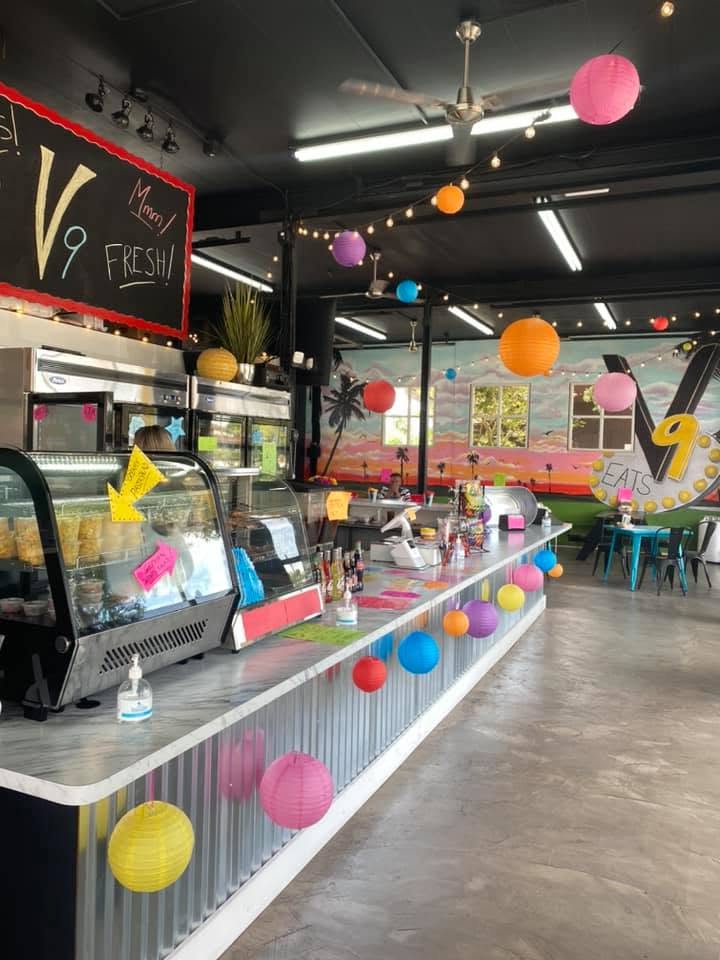 V9's counter strung with colourful paper lanterns and string lights
