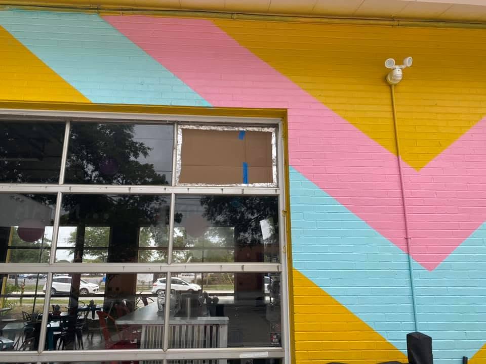 The pink, teal and yellow chevron wall around a garage-bay window