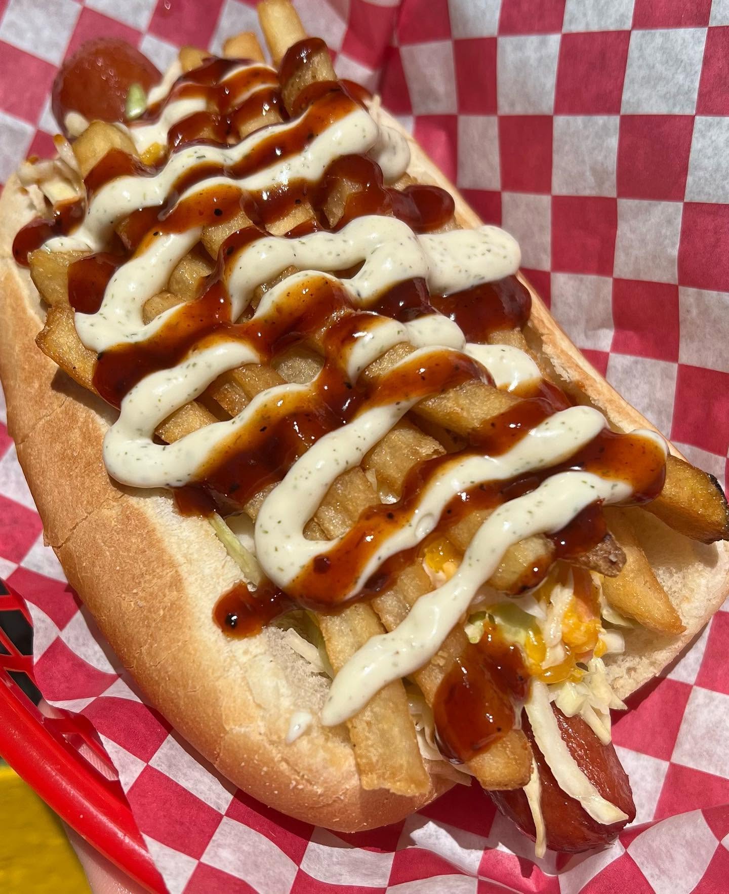 The Saint Pete Dog topped with BBQ sauce, dill sauce, slaw and fries