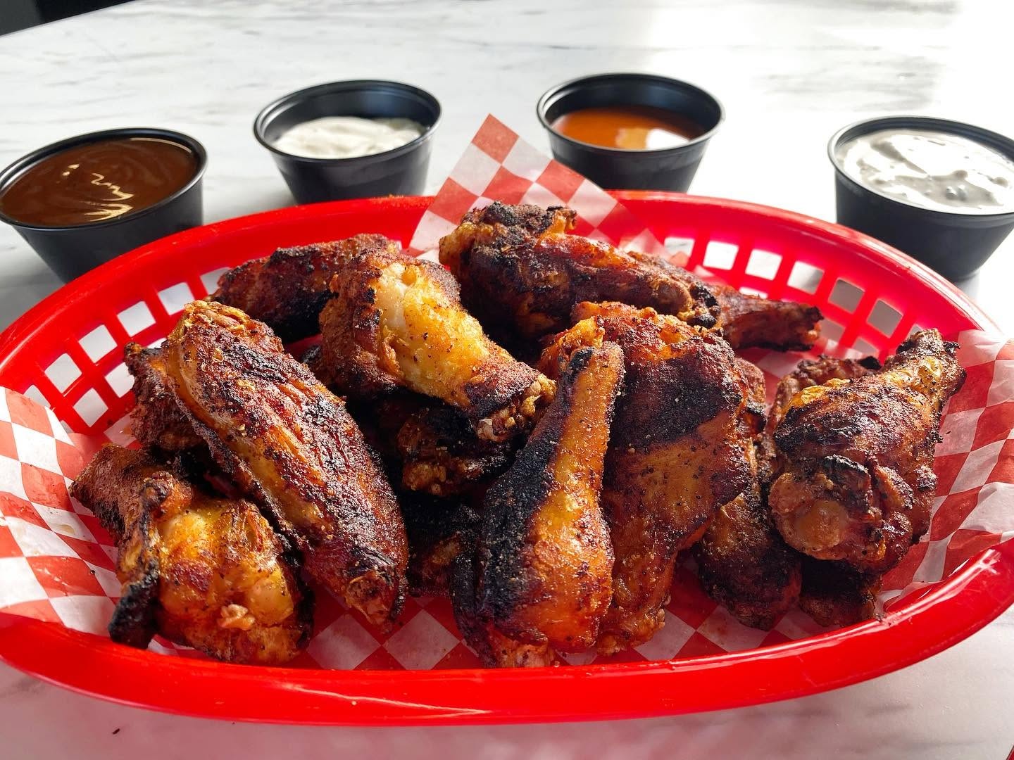 Wings with four cups of house dipping sauces